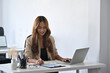 © Prathankarnpap - Attractive businesswoman analyzing financial statistics on laptop computer.