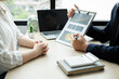 © Orathai - Two business leaders talk about charts, financial graphs showing results are analyzing and calculating planning strategies, business success building processes