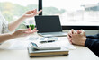 © Orathai - Two business leaders talk about charts, financial graphs showing results are analyzing and calculating planning strategies, business success building processes