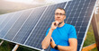 Portrait young male farmer in glasses on background of solar panels. Concept maintenance of electrical elements is self sufficient