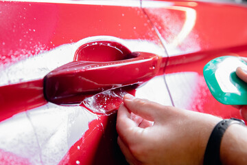 Wall Mural - Paint protection is vinyl film in zone risk under handles red car