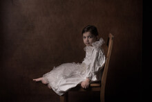 Renaissance Portrait Of A Young Girl In White Classic Dress With Collar On Chair