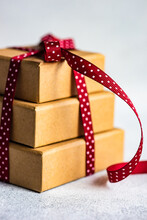 Stack Of Three Gift Boxes Tied With A Red Ribbon