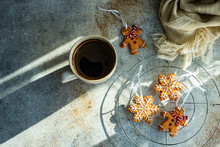 Cup Of Black Coffee, Snowflake And Gingerbread Men Christmas Cookies On A  Table