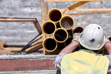 Wall Mural - Handyman construction worker with big yellow pipes.