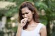 © 9nong - asian woman having nose irritation or nasal allergy