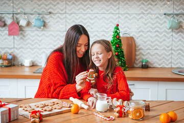 Happy family mother and daughter bake cookies for Christmas