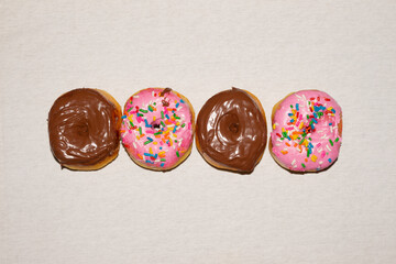 Donuts of various flavors Strawberry, Chocolate and Cream topping. Colorful Confectionery. Top view photography of home made donuts.