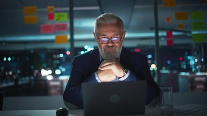 Poster - Portrait of a Senior Experienced Businessman Talking with Clients on Video Call in Modern Office at Night. Management Conference Call on Laptop Computer with Partners, Colleagues, Family or Friends.