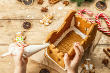 Children's Hand Decorate Gingerbread House By Sweet Icing. Handmade Process, Festive New Year Decor
