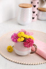 Canvas Print - Beautiful bright flowers in cup on table