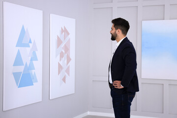 Wall Mural - Young man at exhibition in art gallery