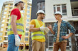 © zinkevych - Engineer and two workers communicating at construction site