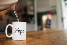 Hot Water Being Poured Into A Mug With The Word Hope Engraved On It
