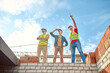 © zinkevych - Men standing on brick wall of building under construction