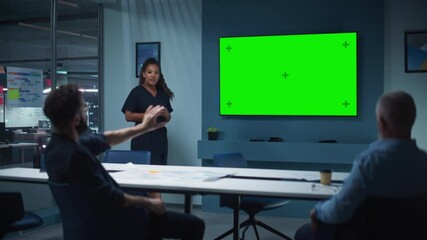 Aufkleber - Company Operations Manager Holds Meeting Presentation for a Team of Executives. Multiethnic Female Uses Wide TV Set with Horizontal Green Screen Mock Up Display. People Work in Business Office.