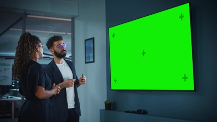 Leinwandbilder - Company Operations Manager Holds Meeting Presentation for the CEO. Adult Male Uses Wide TV Set with Horizontal Green Screen Mock Up Display. People Work in Business Office.