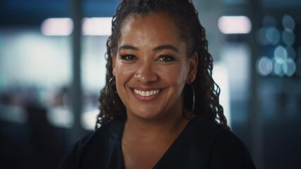 Poster - Portrait of a Confident Happy Adult Middle Aged African American Female Wearing Dark Dress, Looking at Camera, Posing and Charmingly Smiling. Successful Black Woman Working in Diverse Company Office.