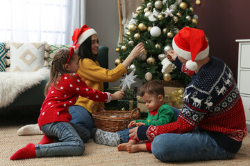 Poster - Family decorating beautiful Christmas tree at home