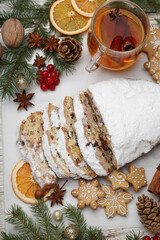 Wall Mural - Traditional Christmas Stollen with icing sugar on white table, flat lay