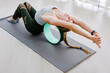 professional yoga lady back around pilates ring lying on gray background floor and showing perfect fitness posture