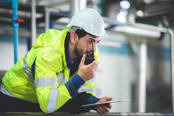 Wall Mural - engineering worker manage working for control a production at industrial manufacturing plant