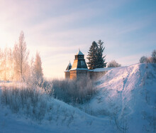 Towers Of Fortress Wall And Church Of Holy Dormition Pskovo Pechersky Male Monastery In The Town Of Pechora, Pskov Region, Russia, On A Winter Day  On A Hill