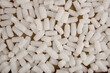 © vaitekune - Styrofoam packing peanuts in cardboard box background. White plastic foam pellets protective for parcel packing.