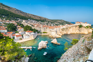 Wall Mural - Old city Dubrovnik panorama. View of town roofs, cliff above the sea and small harbor with boats.