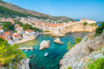 Wall Mural - Old city Dubrovnik panorama. View of town roofs, cliff above the sea and small harbor with boats.