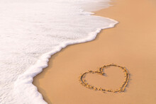 Draw A Heart Shape On The Sandy Beach In The Morning. To Welcome Valentine's Day Festival.