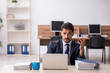 © Elnur - Young male employee sitting at workplace