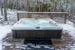 Modern outdoor hot tub on a wooden deck in the cold winter day, Salo, Finland.