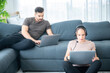© chokniti - woman and man couple working online with laptop for business work at home, happy indoor lifestyle