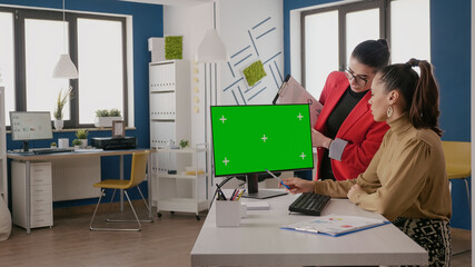Poster - Business people working with green screen on monitor in startup office. Workmates using isolated mock up template and chroma key background on computer, greenscreen on copy space.