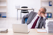© Elnur - Old male employee and too much work in the office