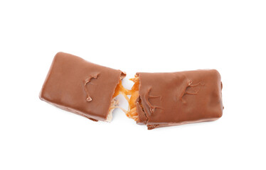 Wall Mural - Broken chocolate bar with caramel, nuts and nougat isolated on white, top view