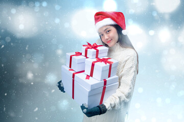 Poster - Asian woman with winter gloves and Santa hat holding white gift box