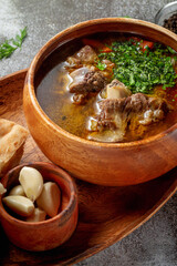 Wall Mural - Beef goulage with garlic and pita bread on a gray stone table, Flatlay