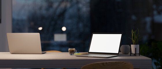 Canvas Print - modern co-working space in office at night with two laptop computer