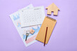 © Pixel-Shot - Wooden house with calendar, notebook and diagrams on lilac background