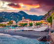 Picturesque summer cityscape of Minori town.  Incredible sunset on Mediterranean cost. Amazing evening scene of Italy, Salerno region, Europe. Vacation concept background.