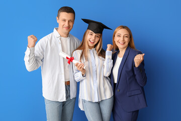 Wall Mural - Happy female graduation student with her parents on color background