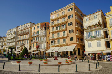 Wall Mural - Picturesque landscape scenic view of Greek Island coastal town city of Corfu Town in Greece with historic ancient old city skyline house building facades, rocks and fortress overlooking bay	