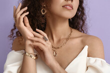 Fashionable African-American Woman With Stylish Jewellery On Color Background