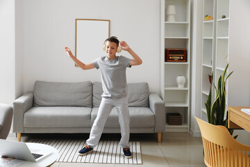 Canvas Print - Funny little boy with laptop learning to dance at home