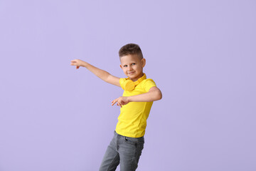 Poster - Cute little boy dancing on color background