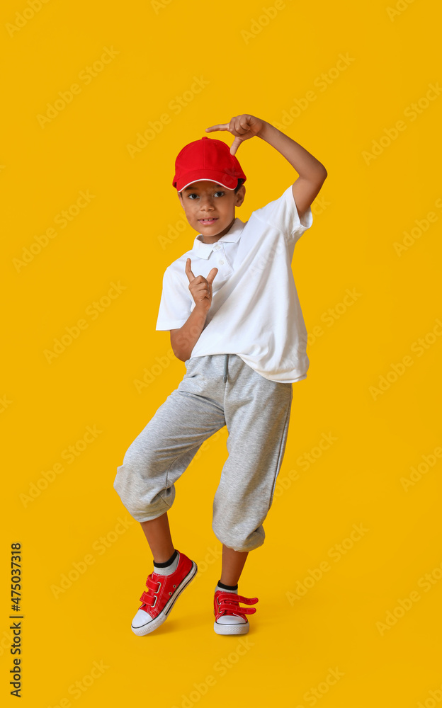 Dancing African-American boy on color background
