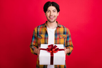 Canvas Print - Photo of adorable excited young gentleman wear plaid outfit smiling holding present box isolated red color background