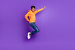 © deagreez - Full length photo of young brunet haired dark skin man jump up dream empty space fly isolated on purple color background